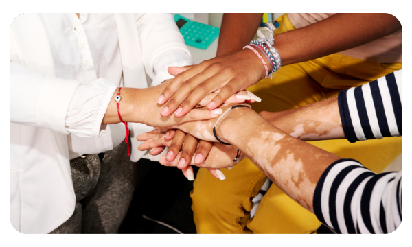 Diverse friends join hands together