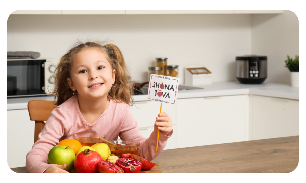 Little girl holds sign that says Shana Tova